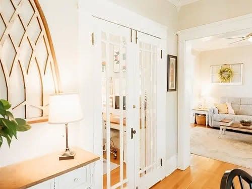 Bright living space with white French doors, cozy lighting, and a comfortable seating area.