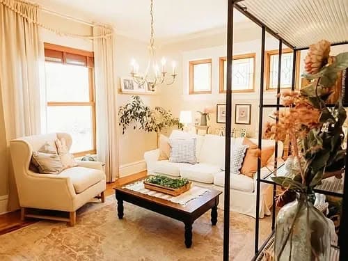 Cozy living room with white sofa, wooden coffee table, and bright natural light.