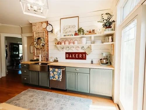 Charming bakery kitchen with open shelves, rustic decor, and modern appliances.