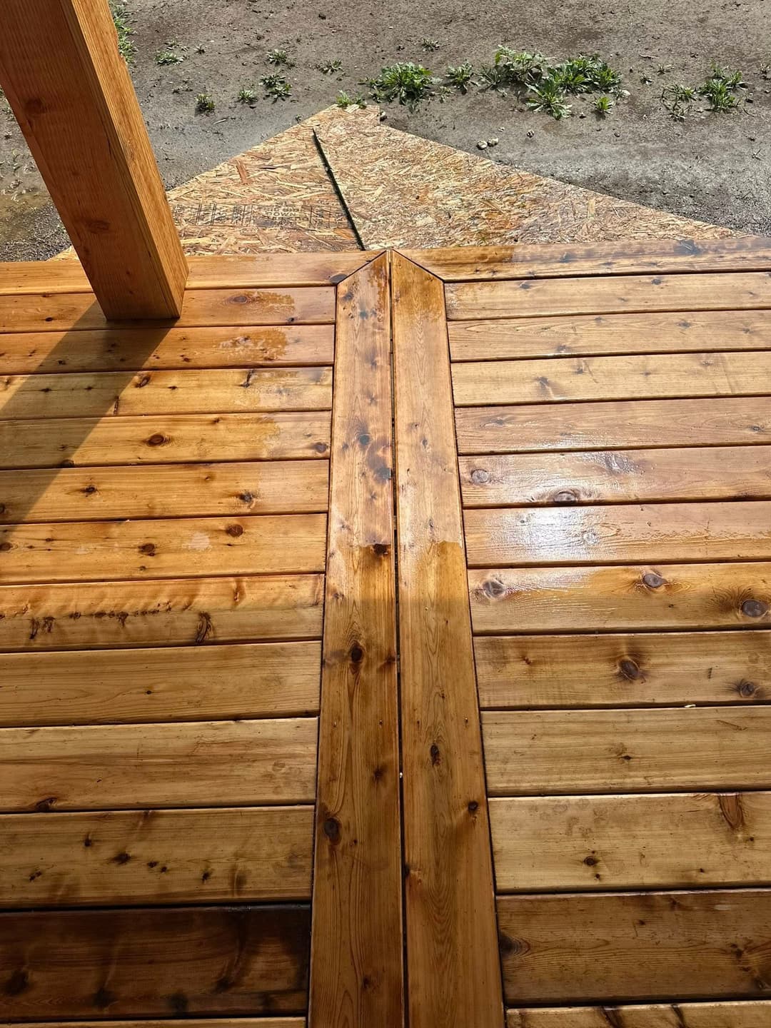 Close-up of newly finished wooden deck boards, showcasing smooth texture and natural wood grain.