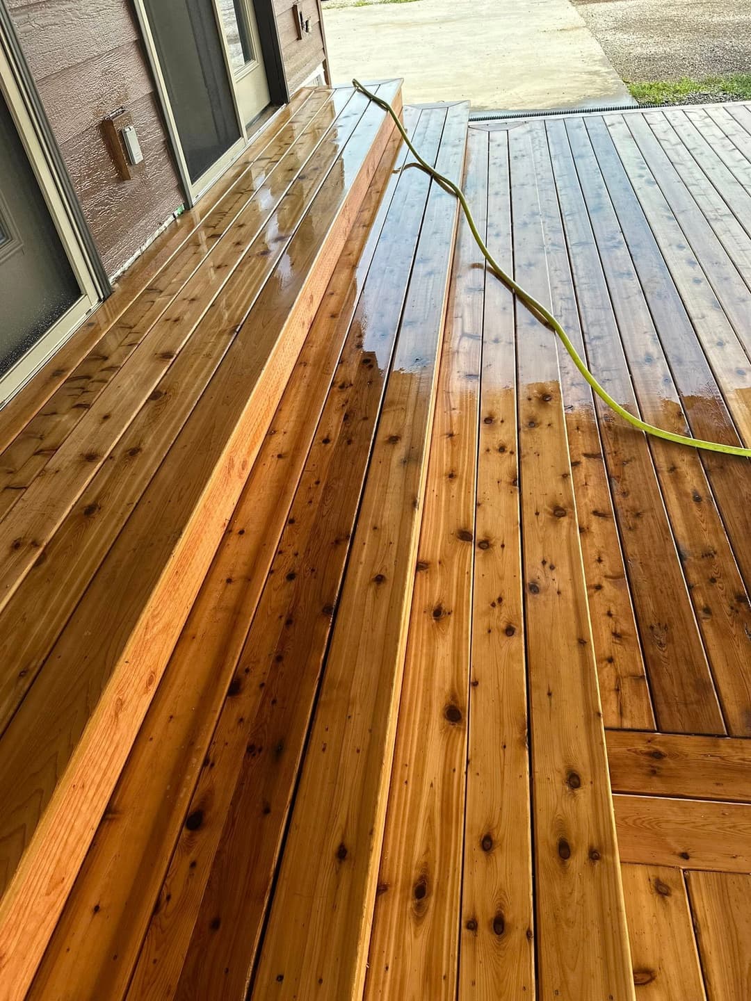 Wooden deck with freshly washed steps and floor, showcasing polished, smooth planks.