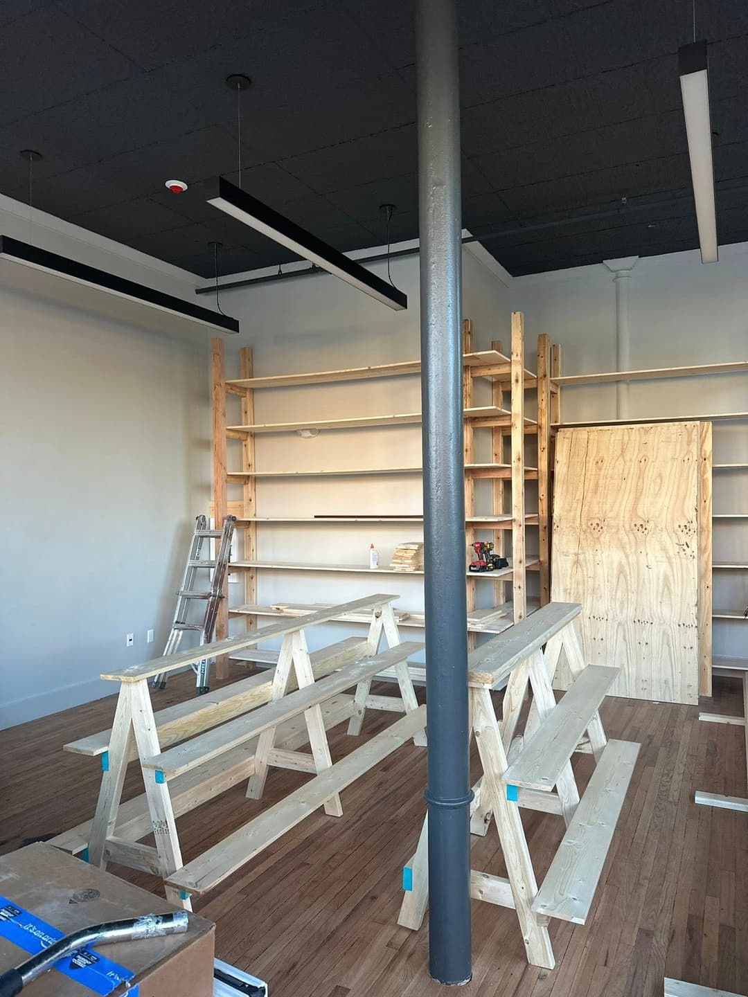 Wooden shelves and benches in a newly constructed retail space with a modern design.